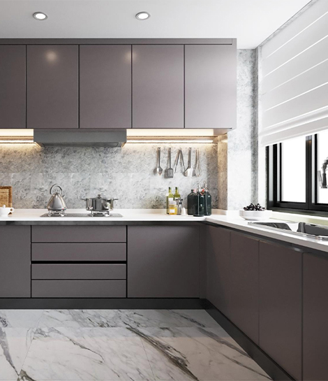 Modern kitchen with gray cabinetry, marble countertop, under-cabinet lighting, and utensils. Ideal for kitchen interiors Mangalore.